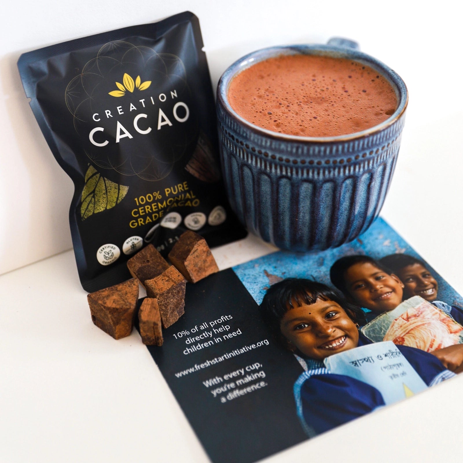 Creation Cacao pack with product flyer and hot chocolate in mug