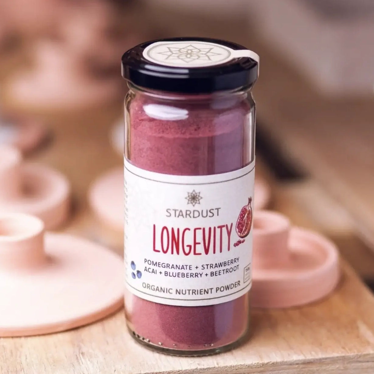 Stardust Longevity Powder Product Shot on a wooden display